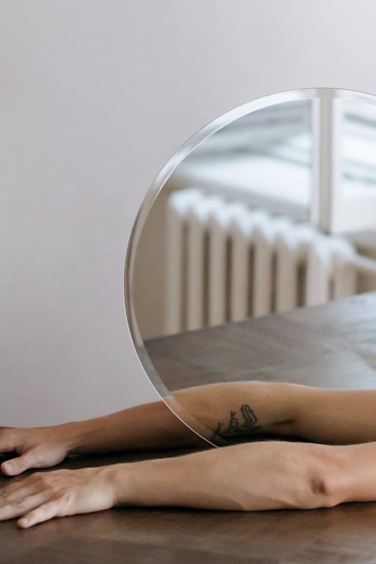 Close-Up Shot of a Person Holding a Mirror